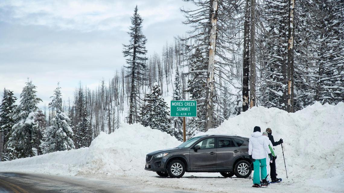 Snow plowed from the road on Idaho 21 makes tall piles along the entrance to a park and ski area at Mores Creek Summit in Boise County on Monday.