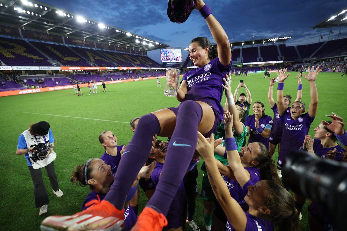 May 5, 2024; Orlando, Florida, USA;  Orlando Pride defender Emily Sams (6) is lifted by teammates after the win against Racing Louisville FC at Inter&Co Stadium. Mandatory Credit: Nathan Ray Seebeck-USA TODAY Sports