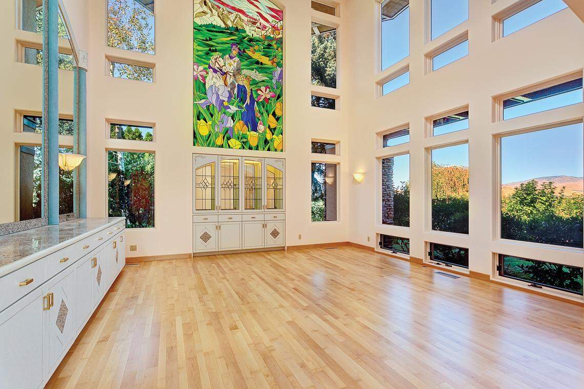 BEFORE: One of the biggest transformation of the grand dining hall. This two-story room and its 17-foot tall stained glass window is now two rooms -- a dining room and an upstairs media room.