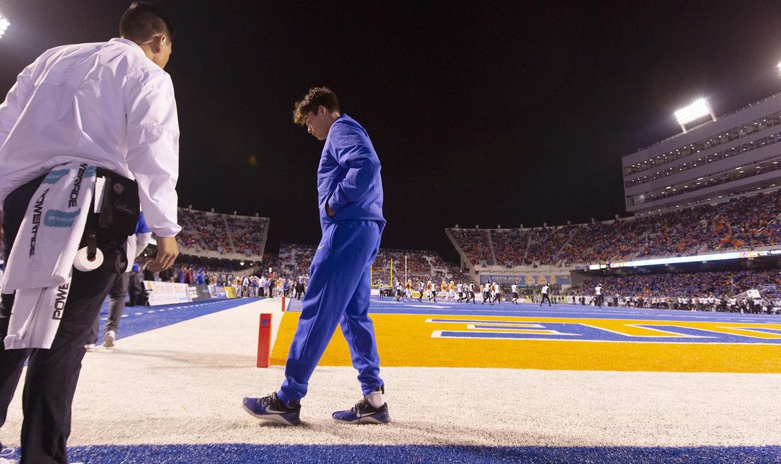 Boise State quarterback Hank Bachmeier (19) walks gingerly back onto the Blue with a trainer in the third quarter after being injured in the Broncos’ 59-37 victory over Hawaii Saturday, Oct. 12, 2019 at Albertsons Stadium in Boise.