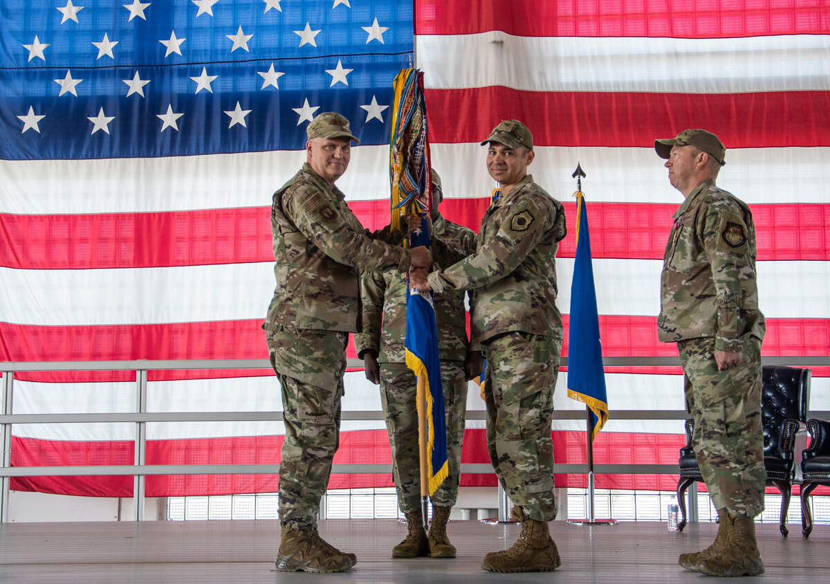 Col. Michael Alfaro, at right holding flag, took command of the 366th Fighter Wing, headquartered at Mountain Home Air Force Base, on July 18. Alfaro will oversee 5,000 airmen and 50 F-15E Strike Eagle aircraft.