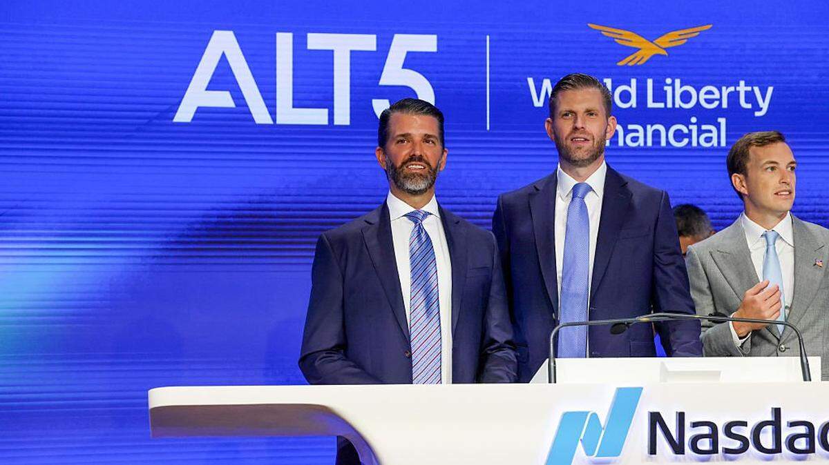 NEW YORK, NEW YORK - AUGUST 13:  Eric Trump (center), the newly appointed ALT5 Board Director of World Liberty Financial, is joined by his brother and ALT5 Board Observer Donald Trump Jr. (left), and Zach Witkoff, Co-Founder and CEO of World Liberty Financial to mark the $1.5B partnership between World Liberty Financial (WLFI) and ALT5 Sigma with the ringing of the NASDAQ opening bell on August 13, 2025 in New York City. The deal, in which ALT5 Sigma acquired 7.5 percent of the total WLFI token supply, marks a step in merging traditional finance with digital assets. (Photo by Spencer Platt/Getty Images)