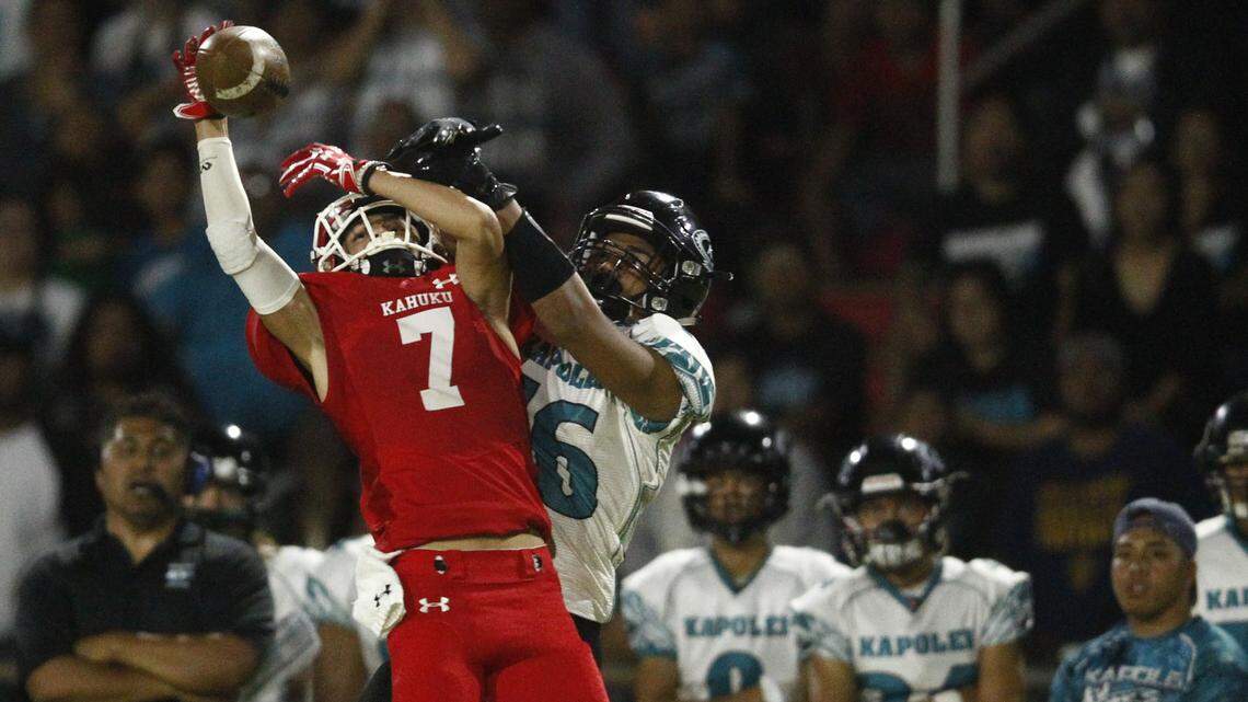 Kahuku defensive back Kaonohi Kaniho breaks up a pass intended for Kapolei wide receiver Keanu Barboza during the first half of an OIA football game on October 13, 2017, in Kahuku, Hawaii.
