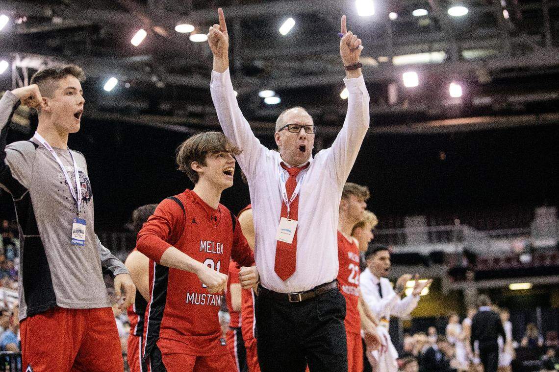 Melba boys basketball coach Spencer Trappett celebrates toward the end of his team’s game against St. Maries for the 2A boys basketball state championship. Melba won 59-50.