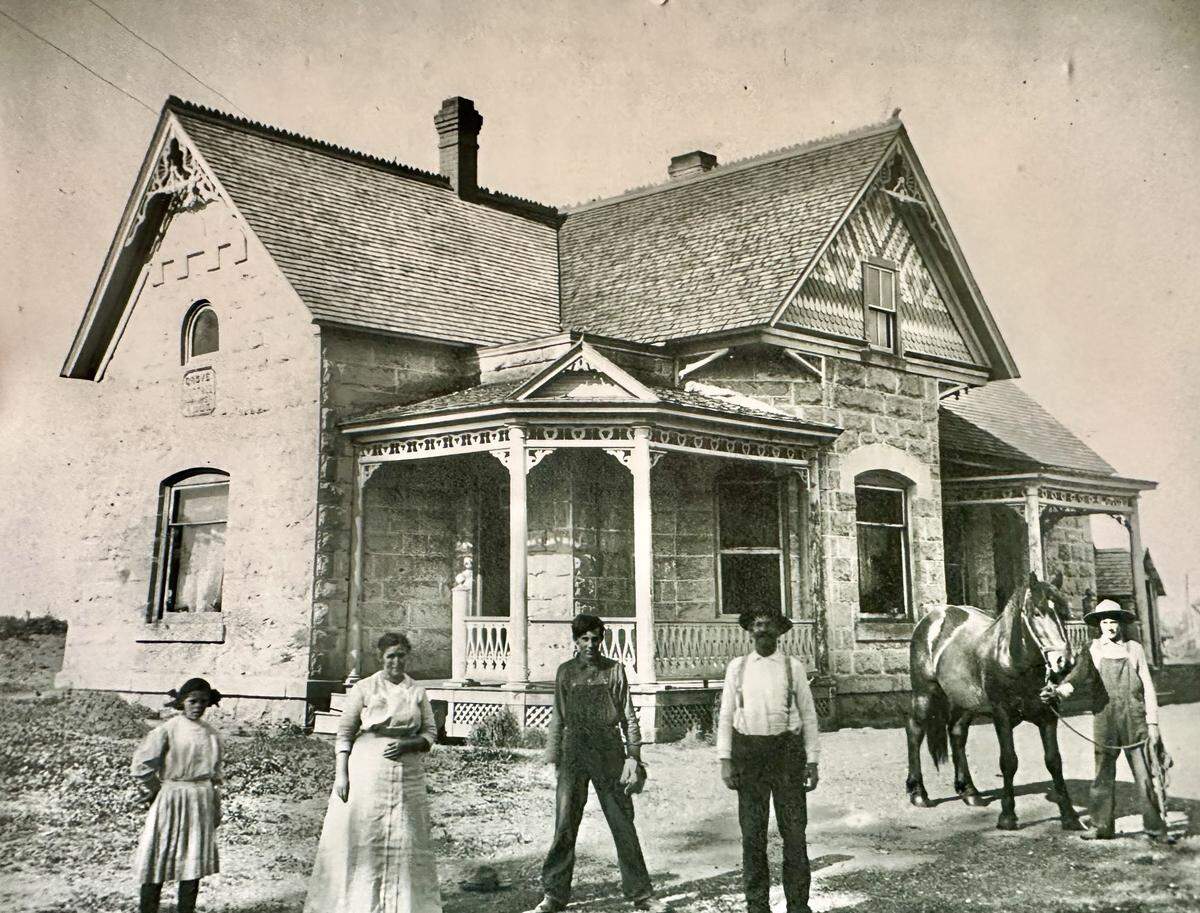 The Parker family built this stone farmhouse in 1905. This is the house that Anita Knapp and her family were living in at the time of the Teton Dam collapse on June 5, 1976. The house was later demolished, but not before the stone plaque, seen on the side of the house on the left side of the photo, was salvaged. That plaque now stands outside the Museum of Rexburg, which contains a Teton Dam flood exhibit.