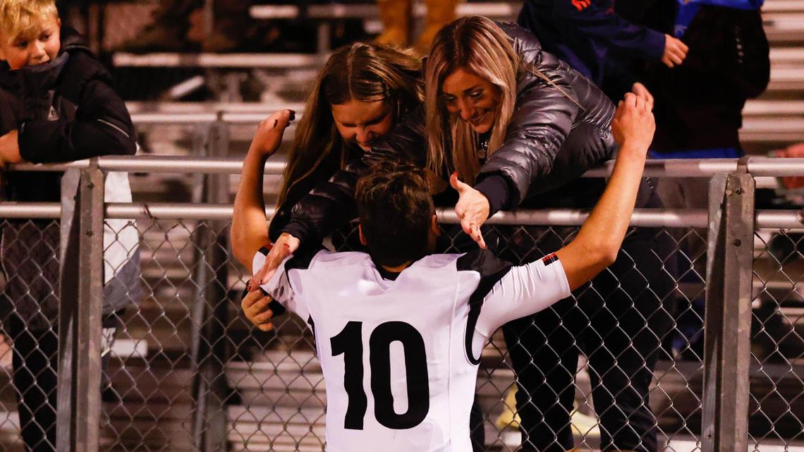 Highland kicker Ian Hershey reaches over the fence for a hug after his game-winning 40-yard field goal lifted the Rams to a 29-27 win over Eagle in the 5A state semifinals Friday at Eagle High.