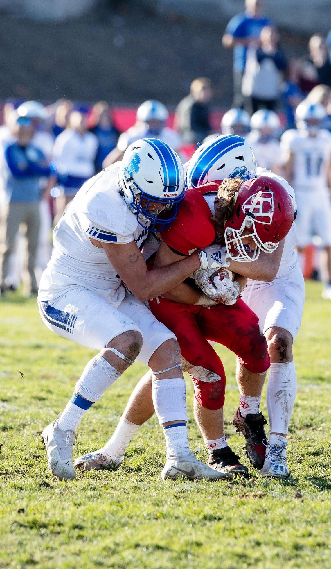 Homedale wide receiver Eli Heck is stopped by Sugar-Salem linebackers Tanner Hawkes, left, and Cooper Porter, on Saturday in the 3A state semifinals.