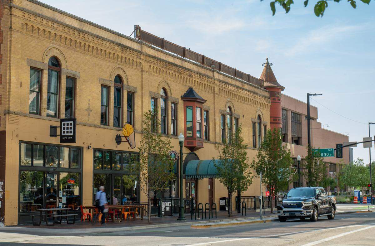 Businesses fill the Adelmann buildings second, first and basement levels, including Boise Fry Co. and Voodoo Cellar. Boise City Hall can be seen at far right, over the “Idaho Street” sign.
