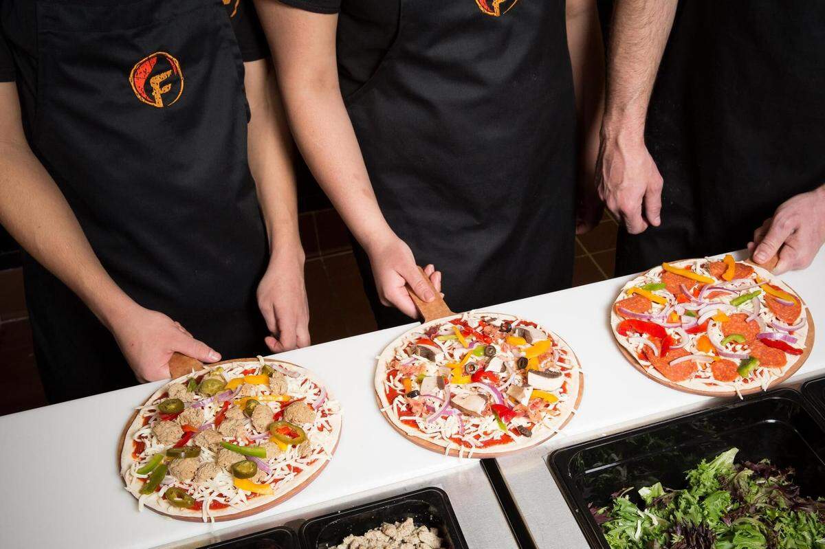 Get your pie made to order in the assembly line at Firenza PIzza.