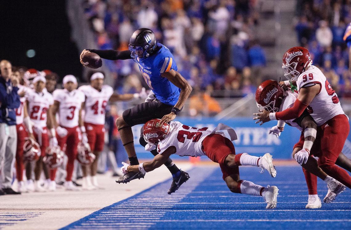 Boise State quarterback Taylen Green goes out of bounds as Fresno State defensive back Braylyn Lux chases him for the stop in the fourth quarter of their game against Fresno State at Albertsons Stadium on Saturday, Oct. 8, 2022. The Broncos 40-20.
