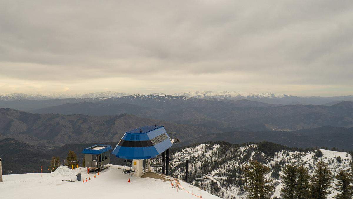 The view at Bogus Basin Mountain Recreation Area on March 13, 2026, from the Pine Creek Cam shows snow at the ski area but bare mountains nearby. Bogus Basin officials announced they would close March 22 after a forecasted heatwave in southern Idaho.
