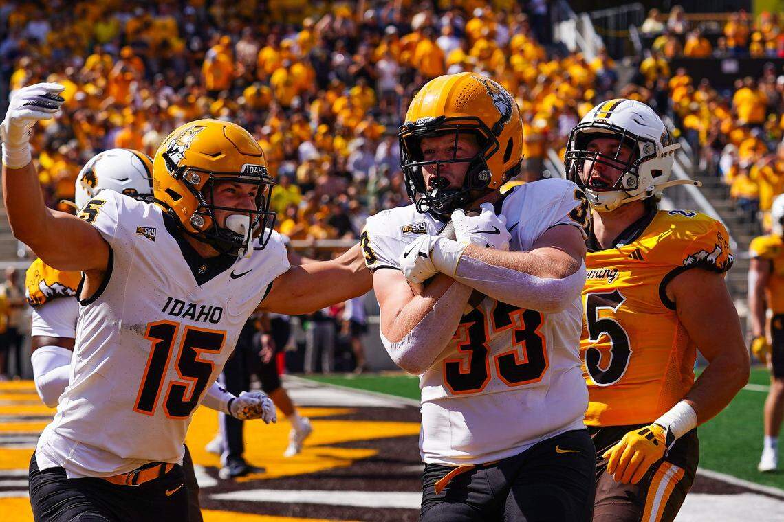Idaho tight end Jake Cox, center, scores a touchdown against Wyoming earlier this season at War Memorial Stadium in Laramie, Wyoming.