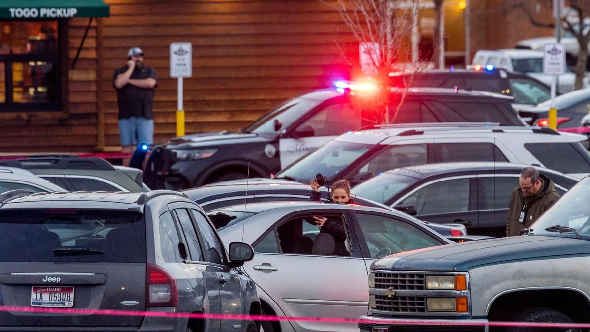 Police gather evidence in the parking lot of Texas Roadhouse restaurant in Meridian, where Boise Police say Eli Nash wanted on felony charges was shot and killed by an officer.