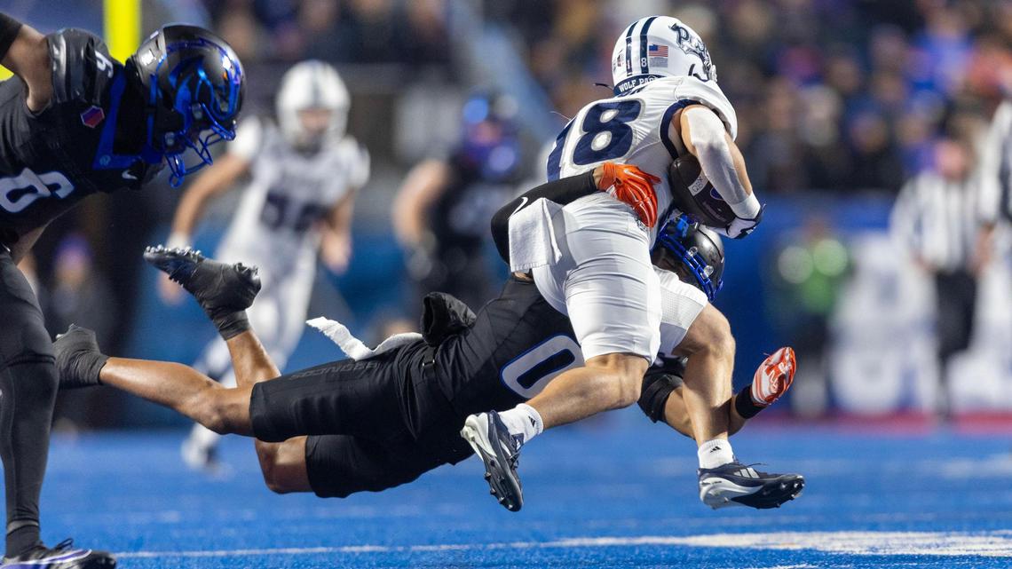 Boise State safety Ty Benefield tackles Nevada wide receiver Marcus Bellon at Albertsons Stadium in Boise, Saturday, Nov. 9, 2024.