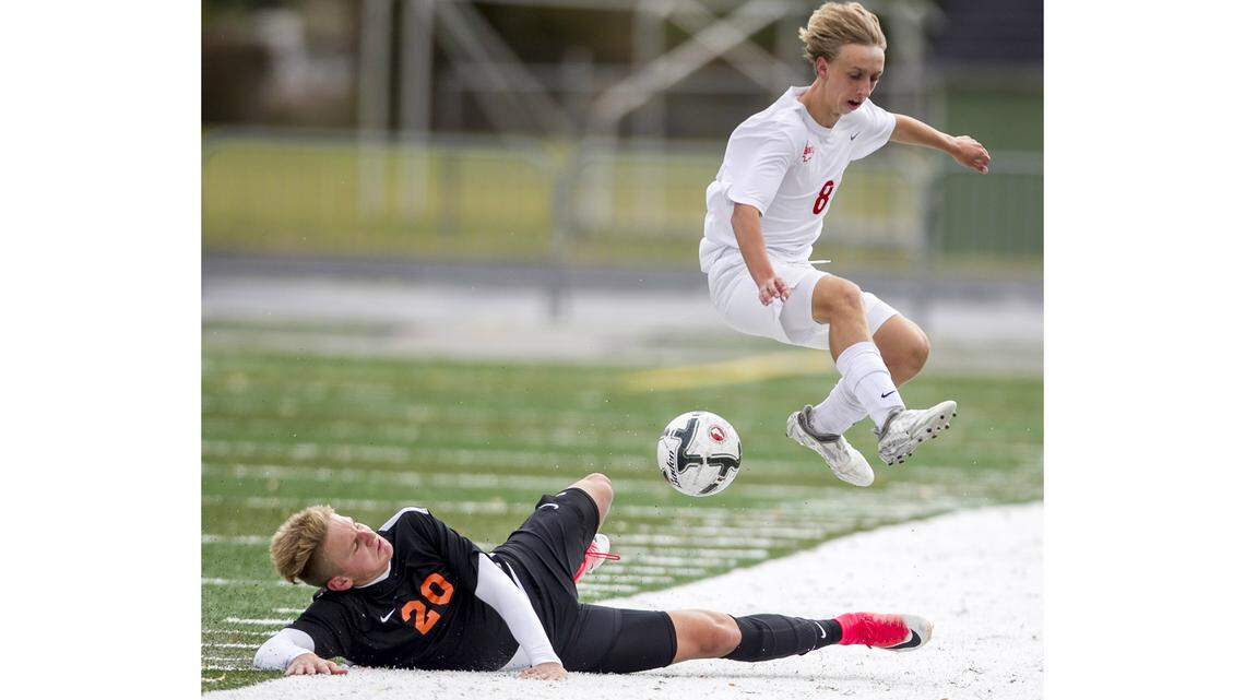 Boise’s Carter Luthy leaps over Post Falls’ Igor Samardzic during the 5A state semifinals last fall at Eagle High.
