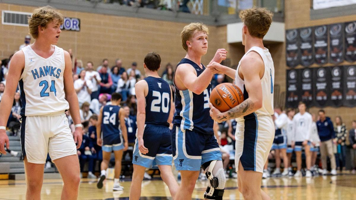 Twin Falls junior Preston Stokes, center, and Skyview senior Eloy Chaparro, right, acknowledge each other at the end of Skyview’s win in the quarterfinals of the 4A boys basketball state tournament Thursday at Rocky Mountain High School. Skyview defeated Twin Falls 48-28.