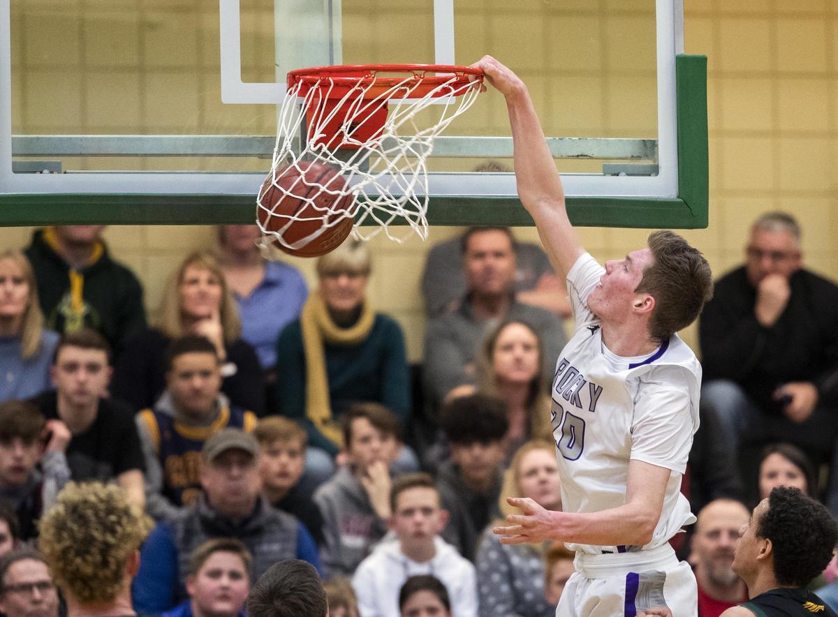 Rocky Mountain’s Briggs Ranstrom throws down a dunk during last year’s district championship game at Borah.