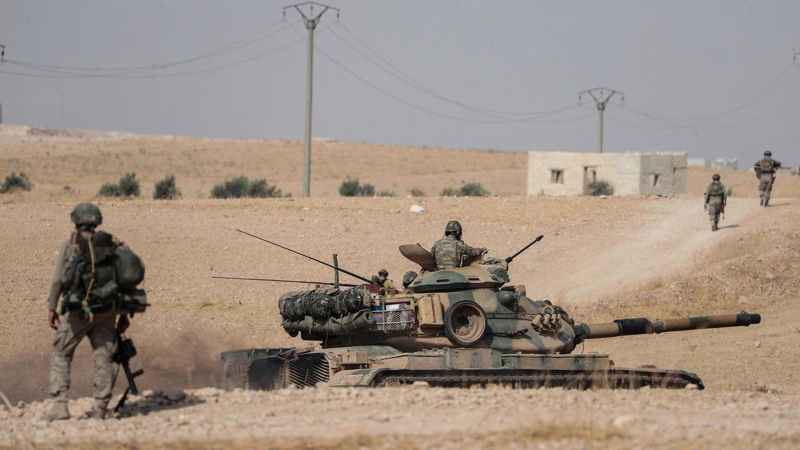 Turkish tanks and troops stationed near Syrian town of Manbij, Syria, Tuesday. Oct. 15, 2019. Russia moved to fill the void left by the United States in northern Syria on Tuesday, deploying troops to keep apart advancing Syrian government and Turkish forces.(Ugur Can/DHA via AP)