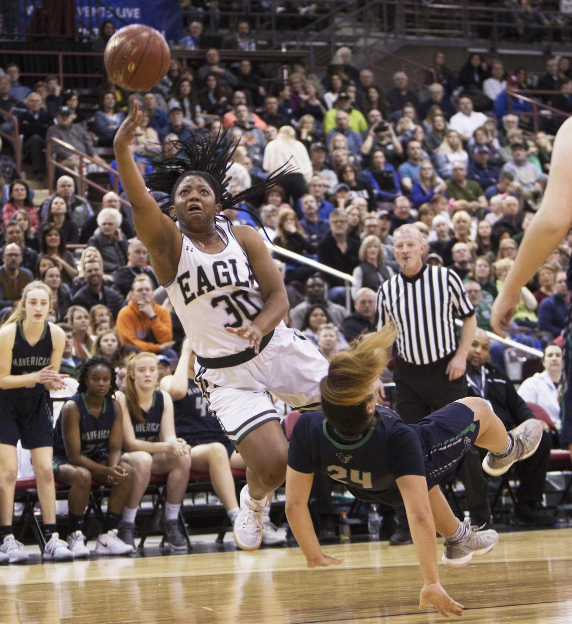 Eagle senior Jaimee McKinnie is fouled by Mountain View’s Trinity Slocum on a drive to the hoop in the state 5A girls basketball championship Saturday, Feb. 16, 2019 at Ford Idaho Center in Nampa.