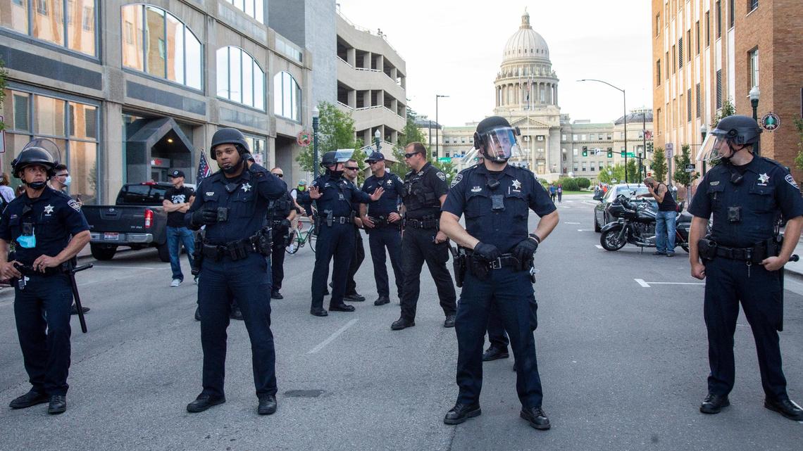 Boise police stand on Capitol Boulevard north of Idaho Street as protesters and counterprotesters gather near City Hall in Downtown Boise in 2020.
