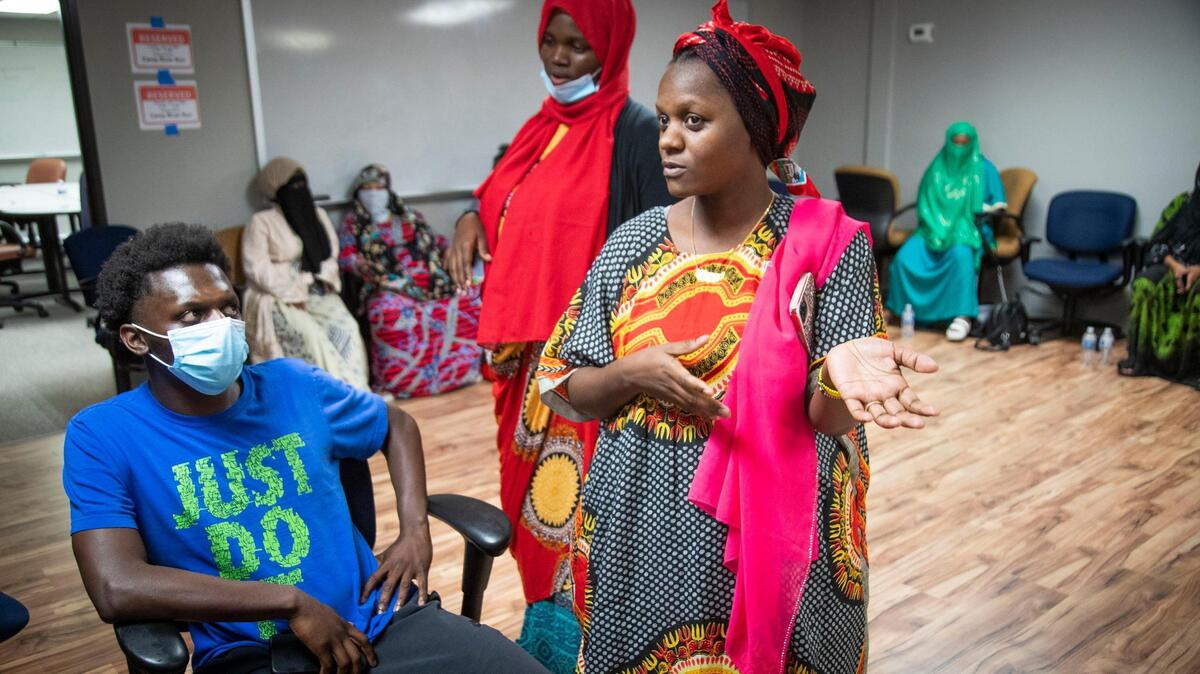 Hawo Mkoma, right, and brother Mohamed Mkoma provide more details about the their brother, Mohamud Hassan Mkoma. Boise refugee community representative Mana Mohamed speaks to another meeting attendee in the background.