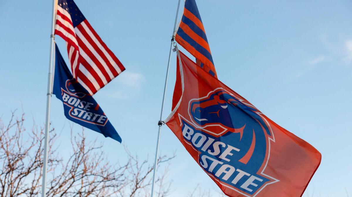 Boise State flags fly along with the United States flag in the Albertsons Stadium parking lot before the Boise State vs. New Mexico game on Nov. 20 in Boise. The Broncos play at San Diego State on Saturday.