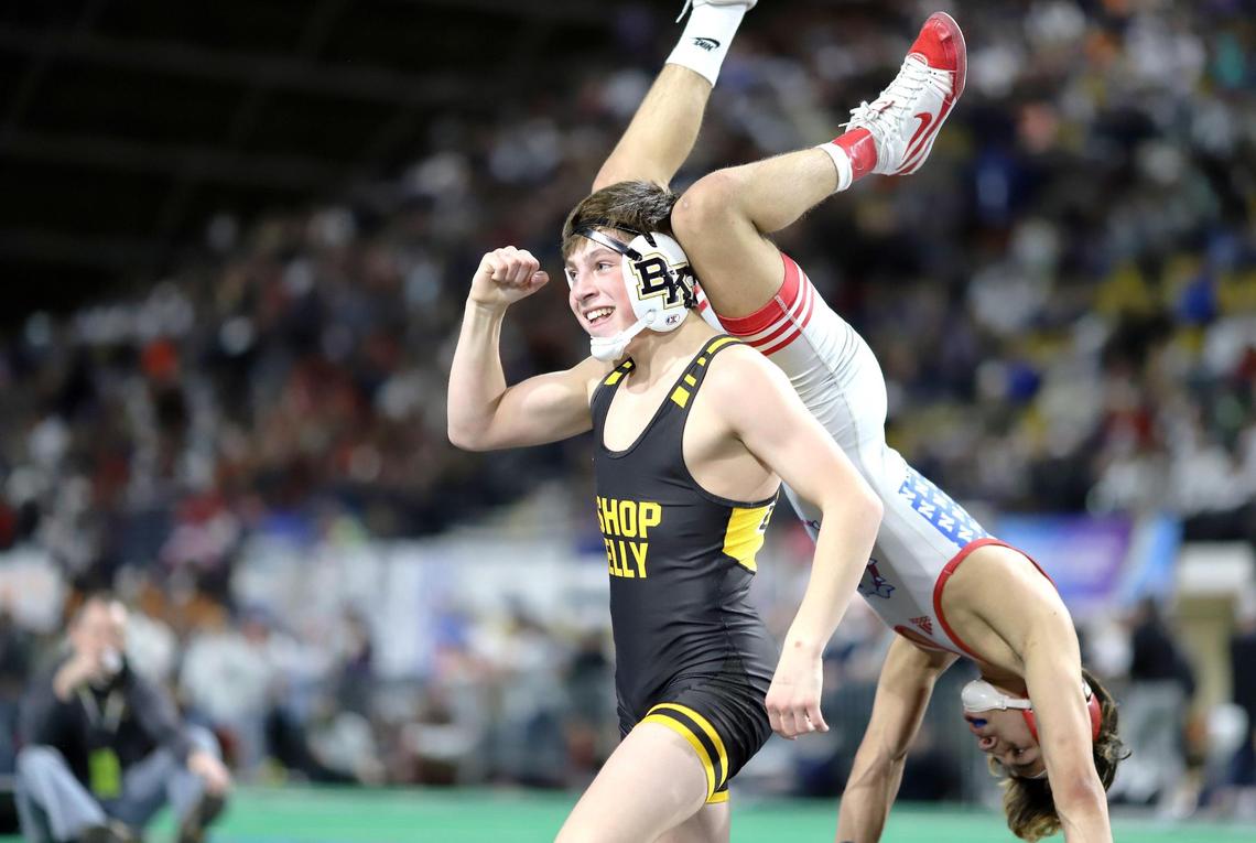 Bishop Kelly freshman Matthew Martino pumps his fist and shakes off Nampa’s Simon Luna after an 8-4 victory for the 4A 106-pound state title Saturday at Holt Arena in Pocatello.