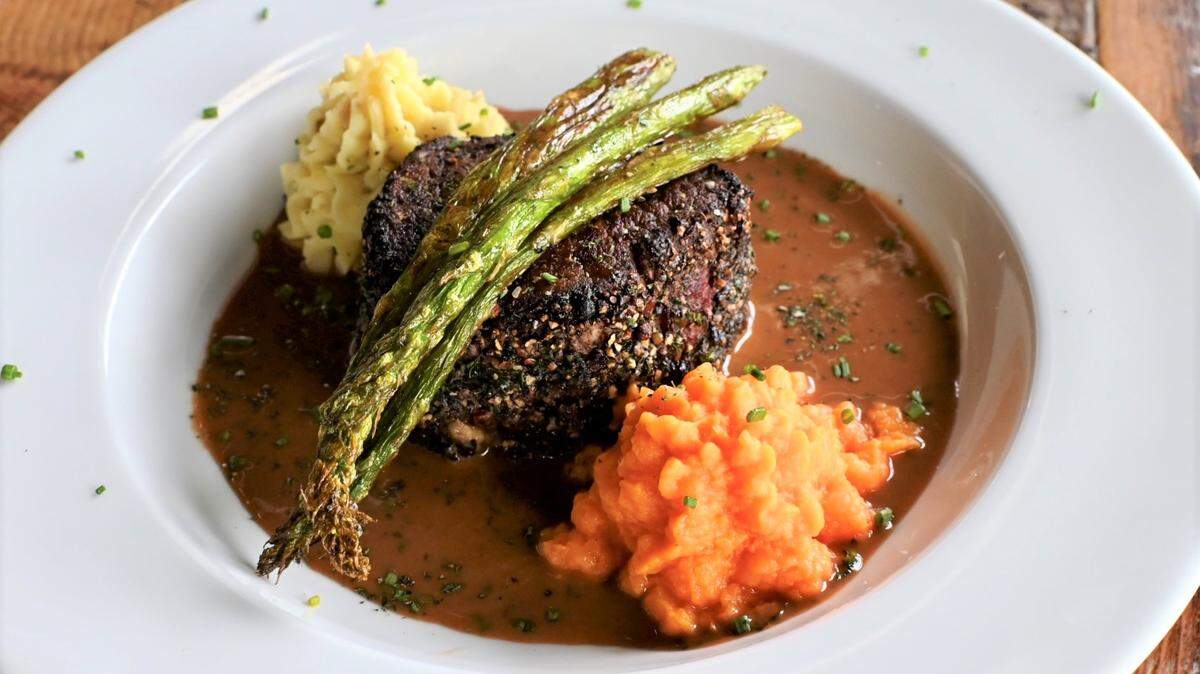 The Amoureux Filet Mignon ($55): The menu describes it as an 8-ounce center-cut filet rolled in crushed, tri-color peppercorns and mixed herbs. It’s served with brandy demi-glace, mashed potatoes, yam puree and asparagus.