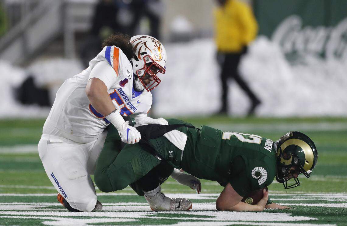 Boise State defensive tackle David Moa, left, sacks Colorado State quarterback Patrick O’Brien in the second half of the Broncos’ 31-24 win on Friday in Fort Collins, Colorado.