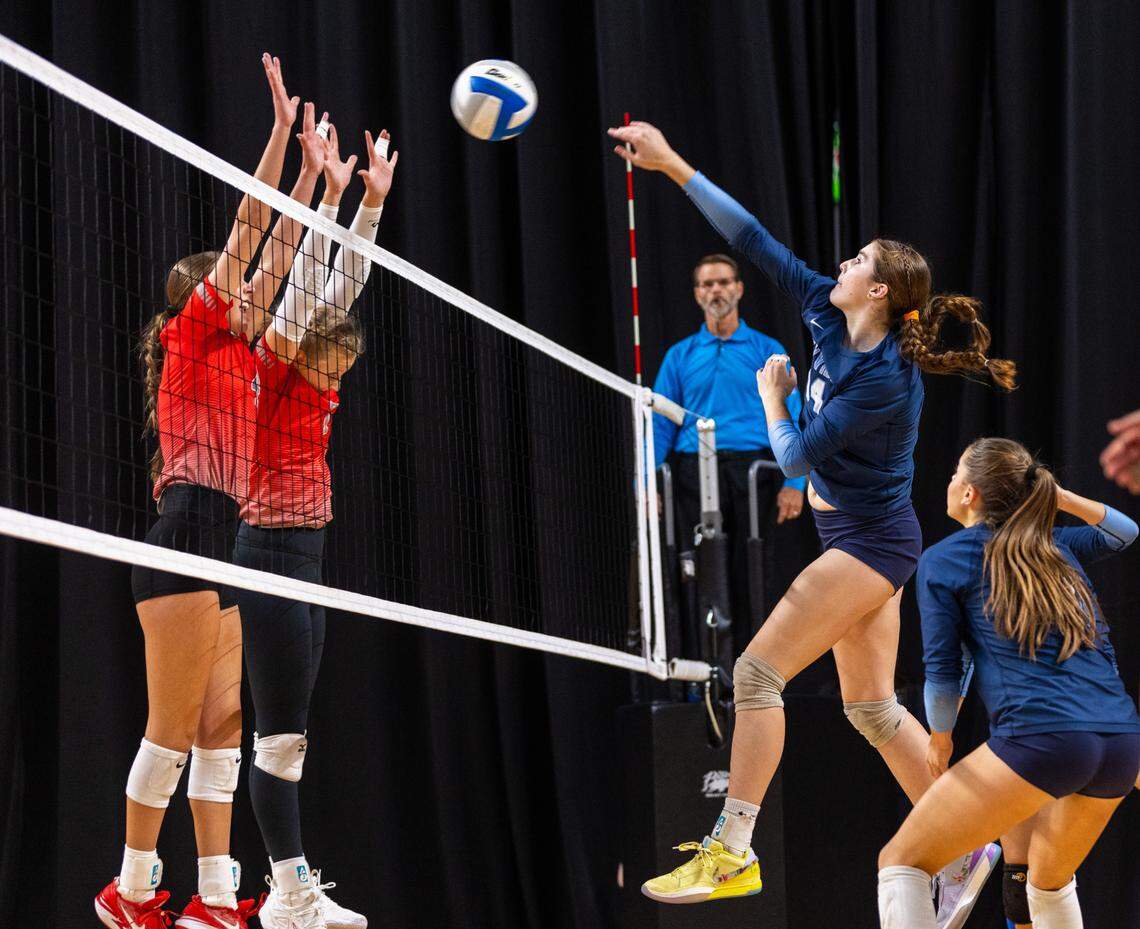Skyview sophomore Jillian Deatherage hits the ball past two Madison blockers on Saturday during the 6A volleyball state tournament at the Mountain America Center in Idaho Falls. Madison defeated Skyview 3-1 to claim the state title.