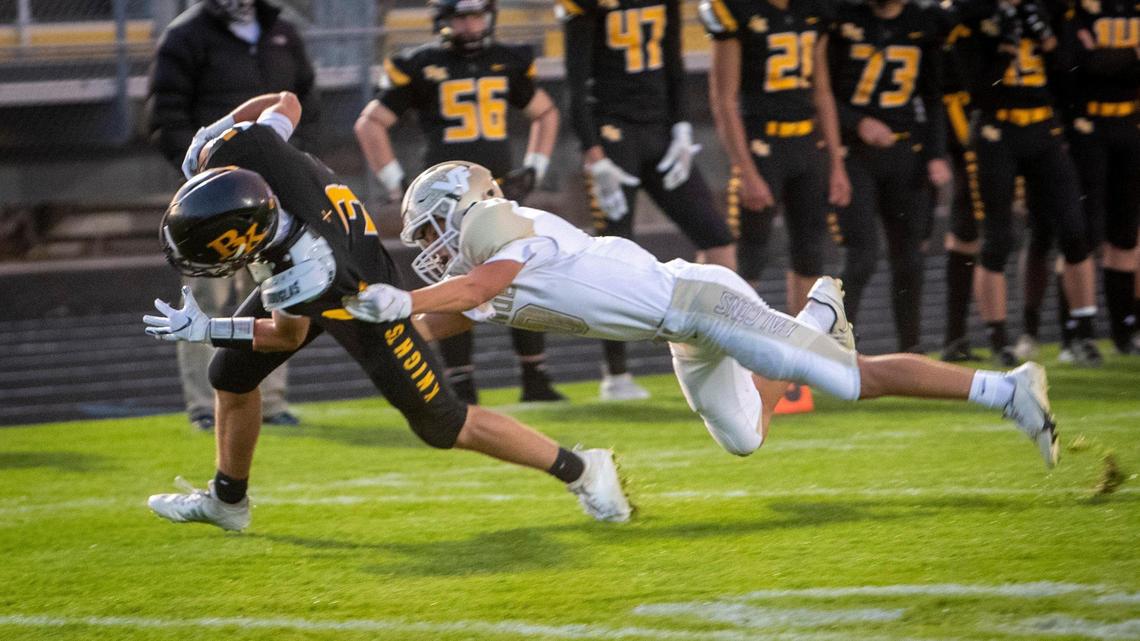 Bishop Kelly’s Jason Buss eludes Vallivue’s Tyson Fox and finds the end zone last season.