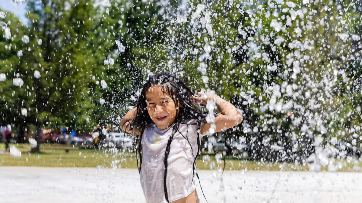 Valeria Campos, 7, plays in the water fountain at Ann Morrison Park in June.