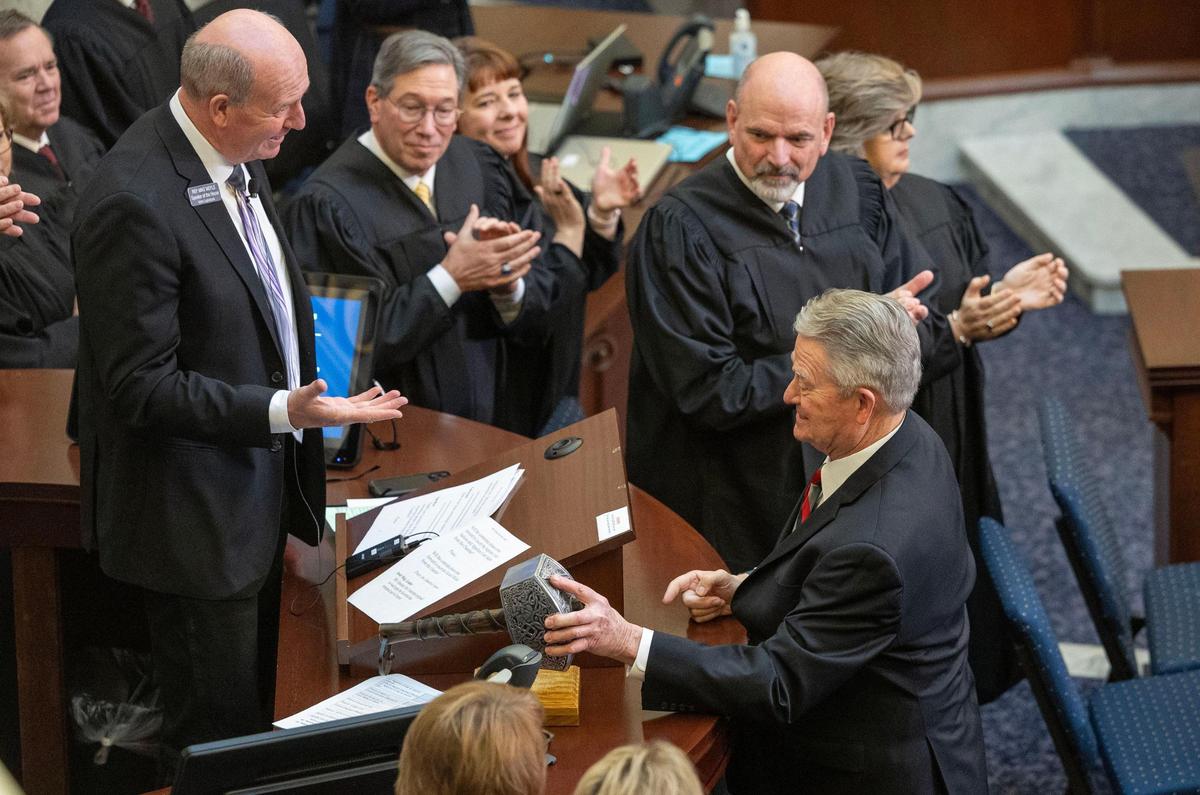 Gov. Brad Little tries to lift House Speaker Mike Moyle’s gavel, a replica of Thor’s hammer Mjölnir. Some lawmakers are vying to increase the legislative branch’s power in Idaho.