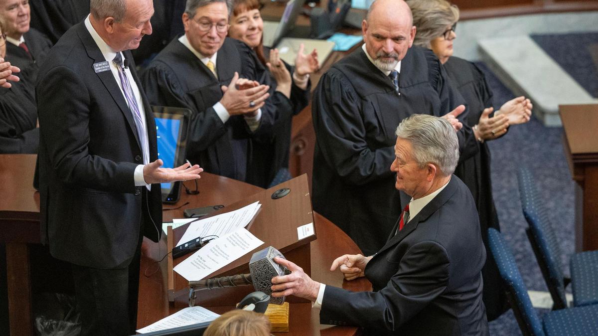 Gov. Brad Little tries to lift House Speaker Mike Moyle’s gavel, a replica of Thor’s hammer Mjölnir. Some lawmakers are vying to increase the legislative branch’s power in Idaho.