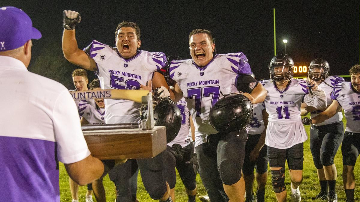 Rocky Mountain’s Javan Taylor (58) and Kevin Croft (77) celebrate after winning the Battle of the Mountains trophy against Mountain View in 2019. The winner of the annual rivalry gets a 50-pound trophy complete with a 3-foot-long ax.