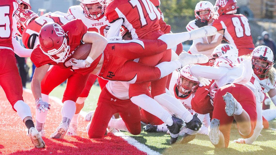 Homedale’s Trenton Fisher dives into the end zone for one of his four touchdowns in a 35-7 win over Weiser in the 3A state semifinals.