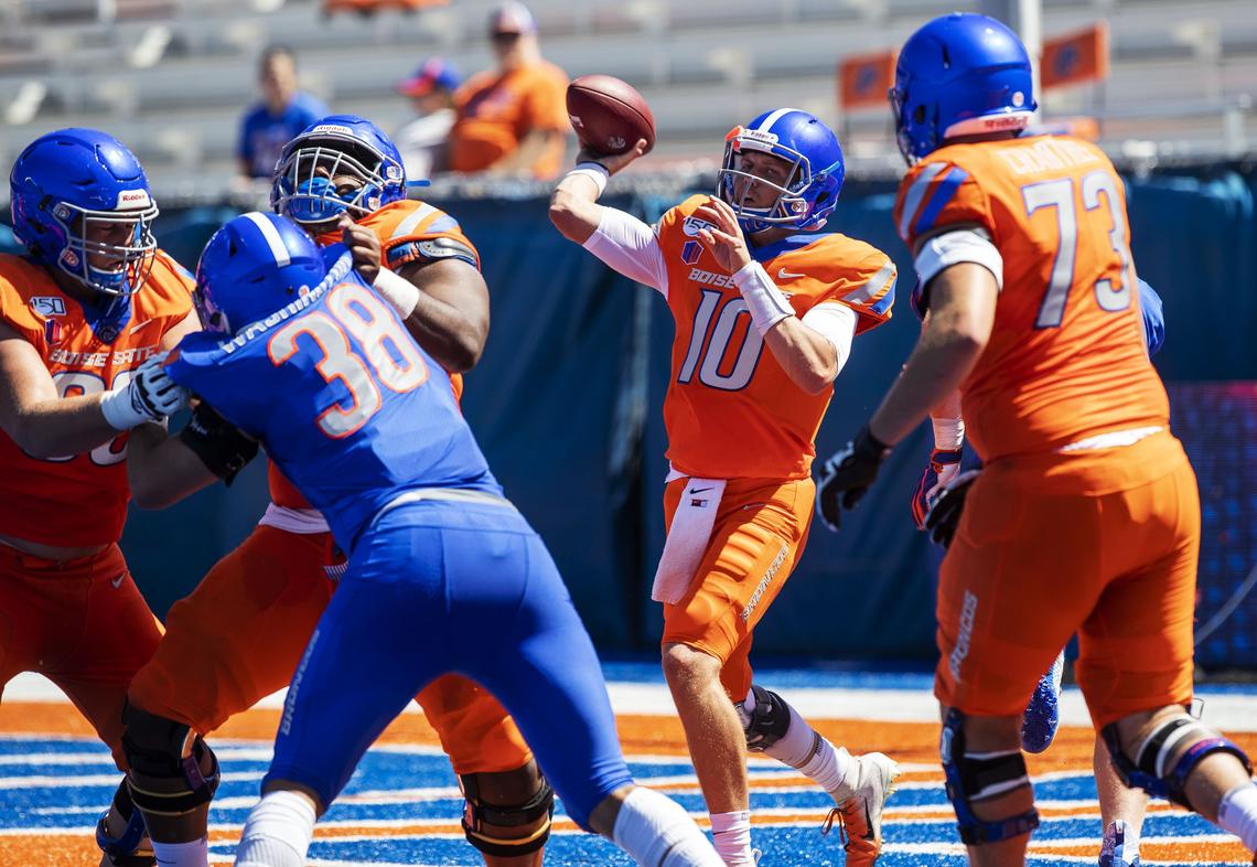 Boise State quarterback Chase Cord gets protection from the offensive line to complete a long pass downfield during the Fall Fan Fest practice Saturday at Albertsons Stadium in Boise.