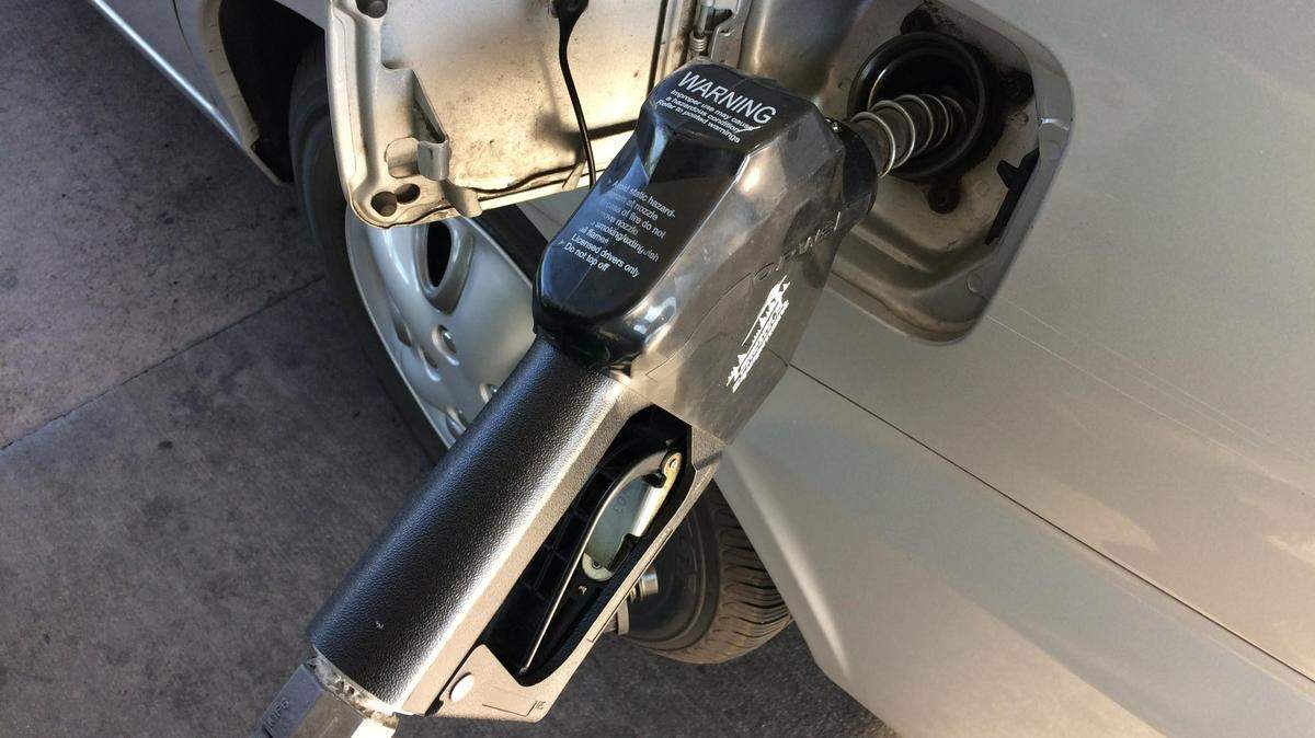 Gasoline pump with handle dispenses fuel into car. Stock, generic. Boise, Idaho, Aug. 31, 2019.