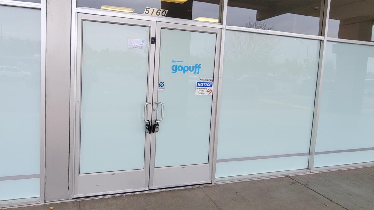 A small window sign is all that identifies the GoPuff storefront at the Hillcrest Shopping Center at 5160 W. Overland Road. The Philadelphia company provides grocery deliveries, but no in-store sales. Painted windows prevent passersby from looking inside.