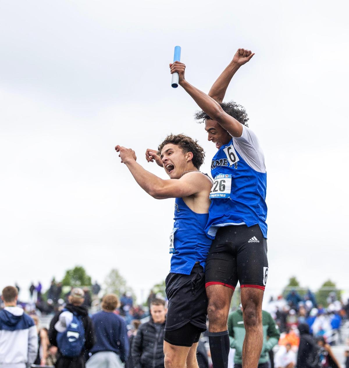 Emmett runners Jax Banuelos, left, and Kenyon Carter jump in the air to celebrate their team’s win in the 5A boys 4x100-meter relay on Saturday at Mountain View High School.