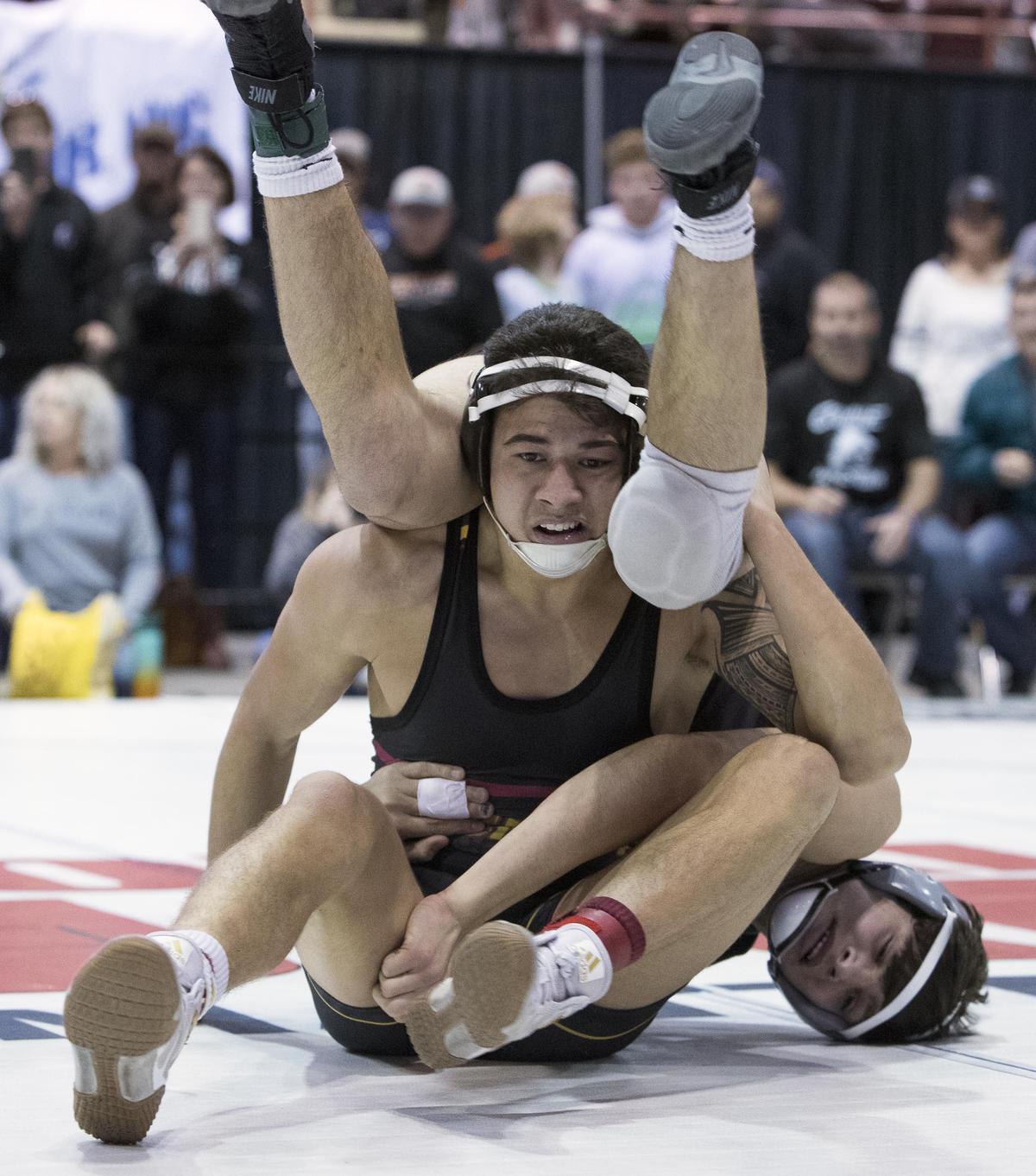 Columbia High’s Kekana Fouret upends Trevor Morrison (Colville) in the 160-pound championship match at the Rollie Lane Invitational Saturday, Jan. 5, 2019 at the Idaho Center in Nampa. Fouret won the title in a 7-3 decision.