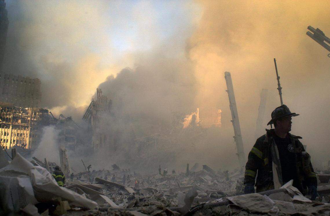 A firefighter moves through piles of debris left after the collapse of the Twin Towers in New York City on Sept. 11, 2001. Lower Manhattan was covered in dust, dirt and debris following the terrorist strikes.