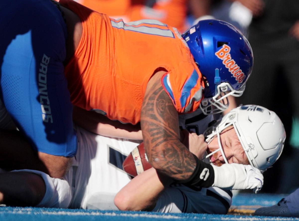Boise State defensive end Ahmed Hassanein takes down Utah State quarterback Spencer Petras during the first half. Boise State defeated Utah State 62-30 at Albertson’s Stadium in Boise, Idaho.