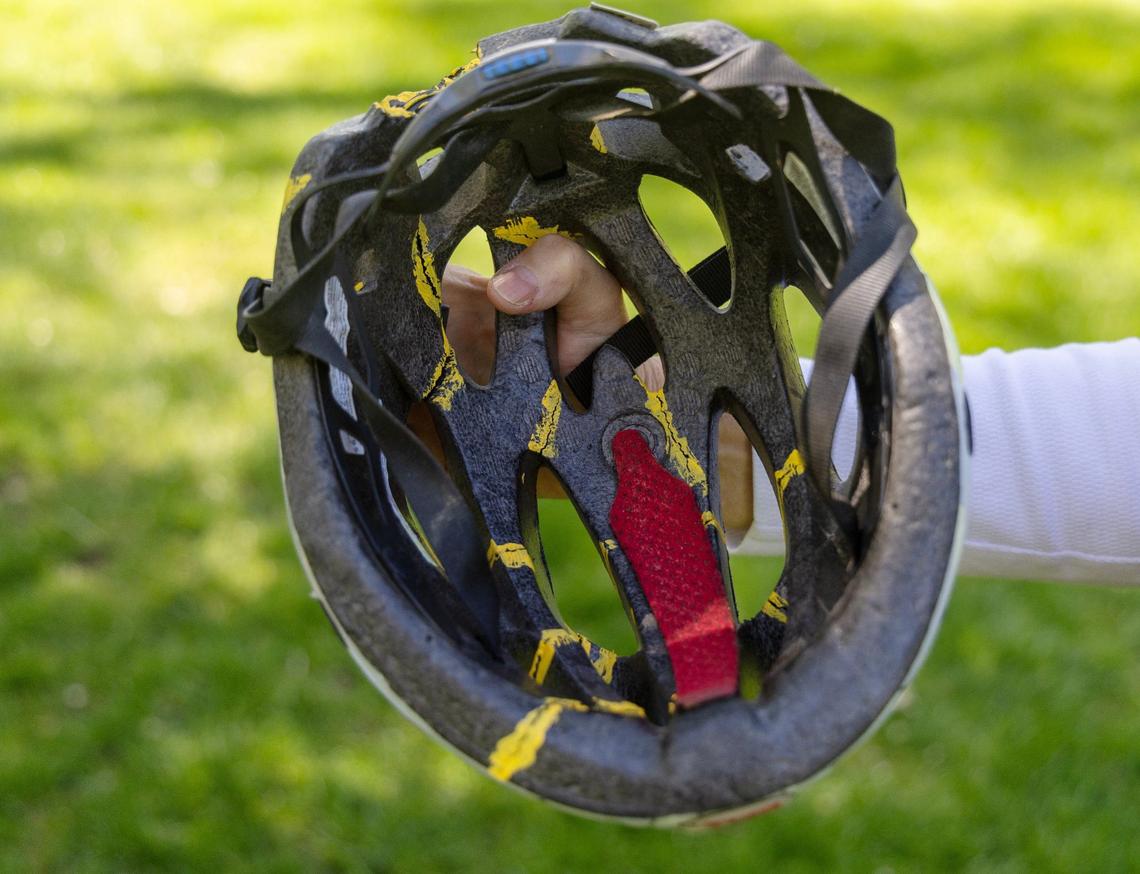 Becky Dodge used yellow paint to mark all the cracks in the helmet her husband Ross Dodge wore when he survived a bicycle crash in 2010 that left him paralyzed.