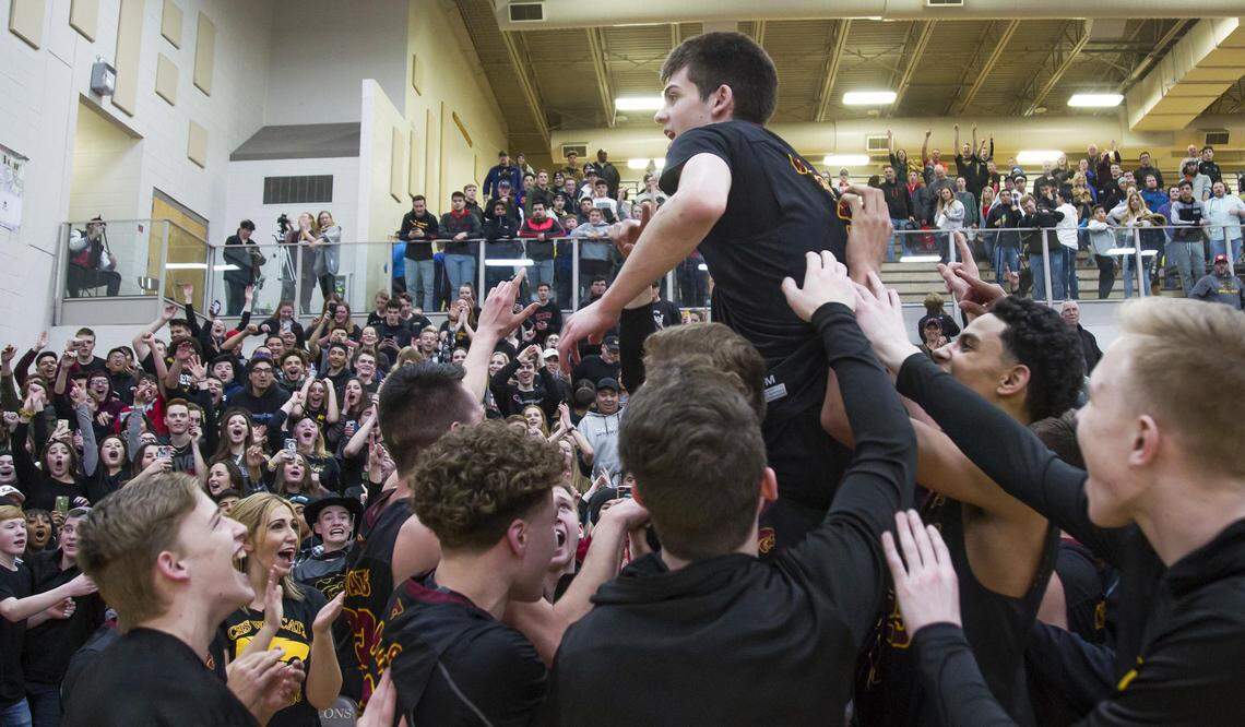 Teammates carry Columbia senior Jake Poulton onto their shoulders after he sank the game-winning 3-pointer against Vallivue in the 4A District Three championship game Feb. 21.