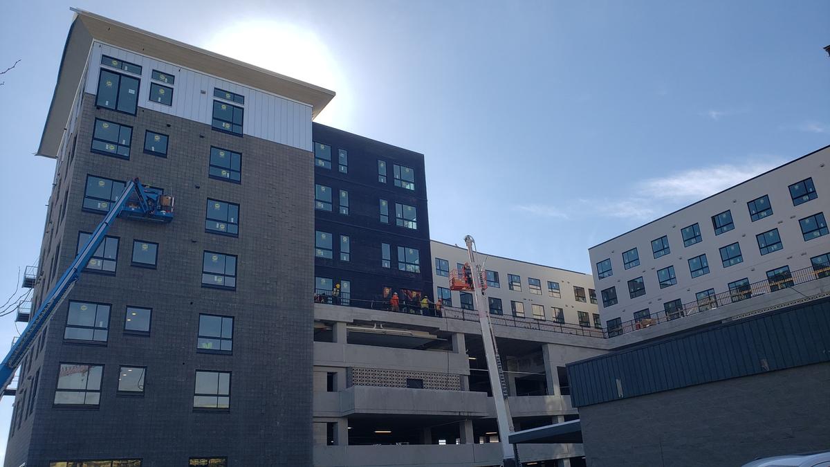 Crews at the Jules on Third apartment building continue to work Friday, a day after a fire broke out on the top floor and roof of the eight-story building. Neither the building’s developer or construction contractor revealed on Friday the extent of the damage.