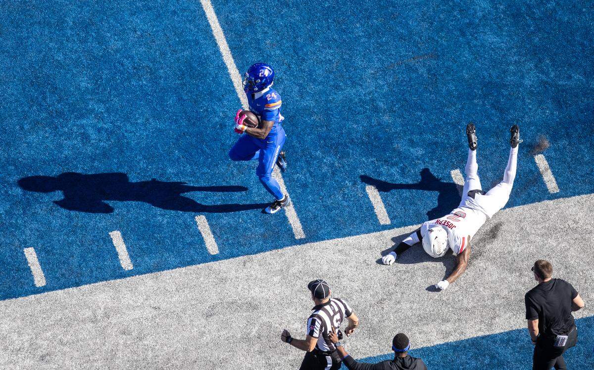 Boise State running back Dylan Riley breaks away from UNLV safety Jaheem Joseph on a long second-quarter run.