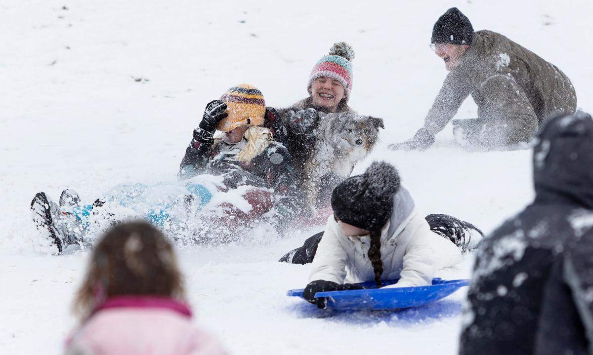 Teens sledding on Simplot Hill in Boise at the corner of Bogus Basin and Cartwright roads.