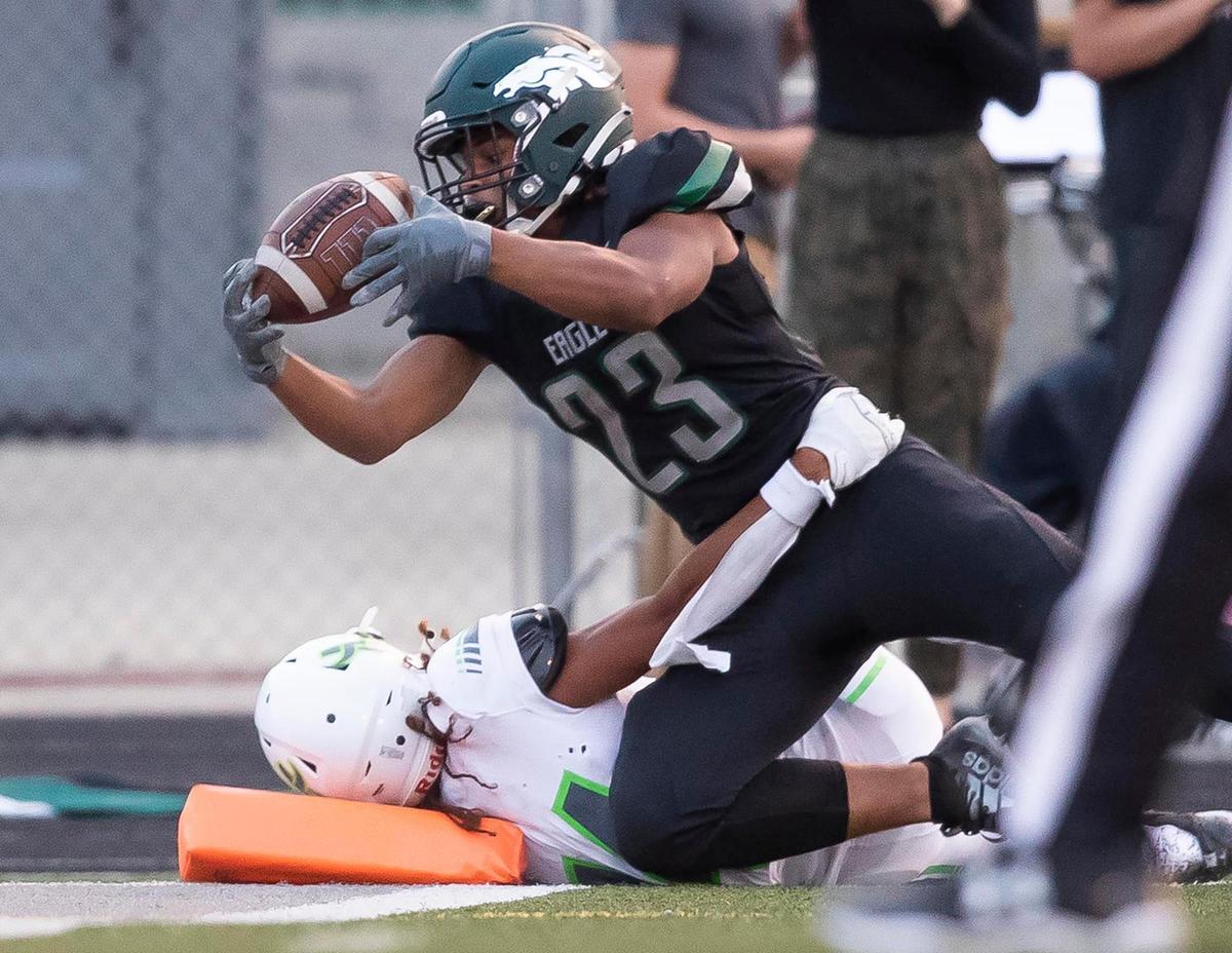 Eagle running back Jackson Stamfli finishes a 82-yard touchdown run with a dive to the end zone Friday at Thunder Stadium in Eagle.