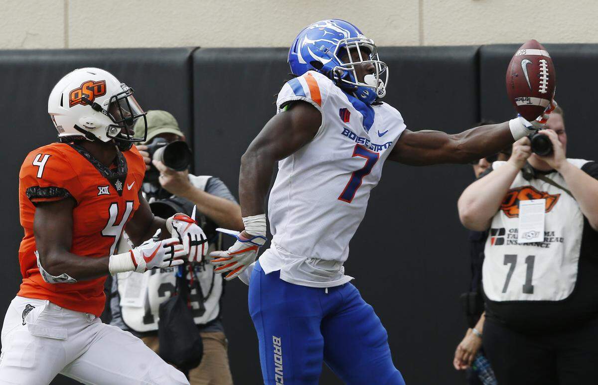 Boise State wide receiver A.J. Richardson (7) makes a one-handed catch on a touchdown pass in front of Oklahoma State cornerback A.J. Green (4) in the second half of an NCAA college football game in Stillwater, Okla., Saturday, Sept. 15, 2018. (AP Photo/Sue Ogrocki)